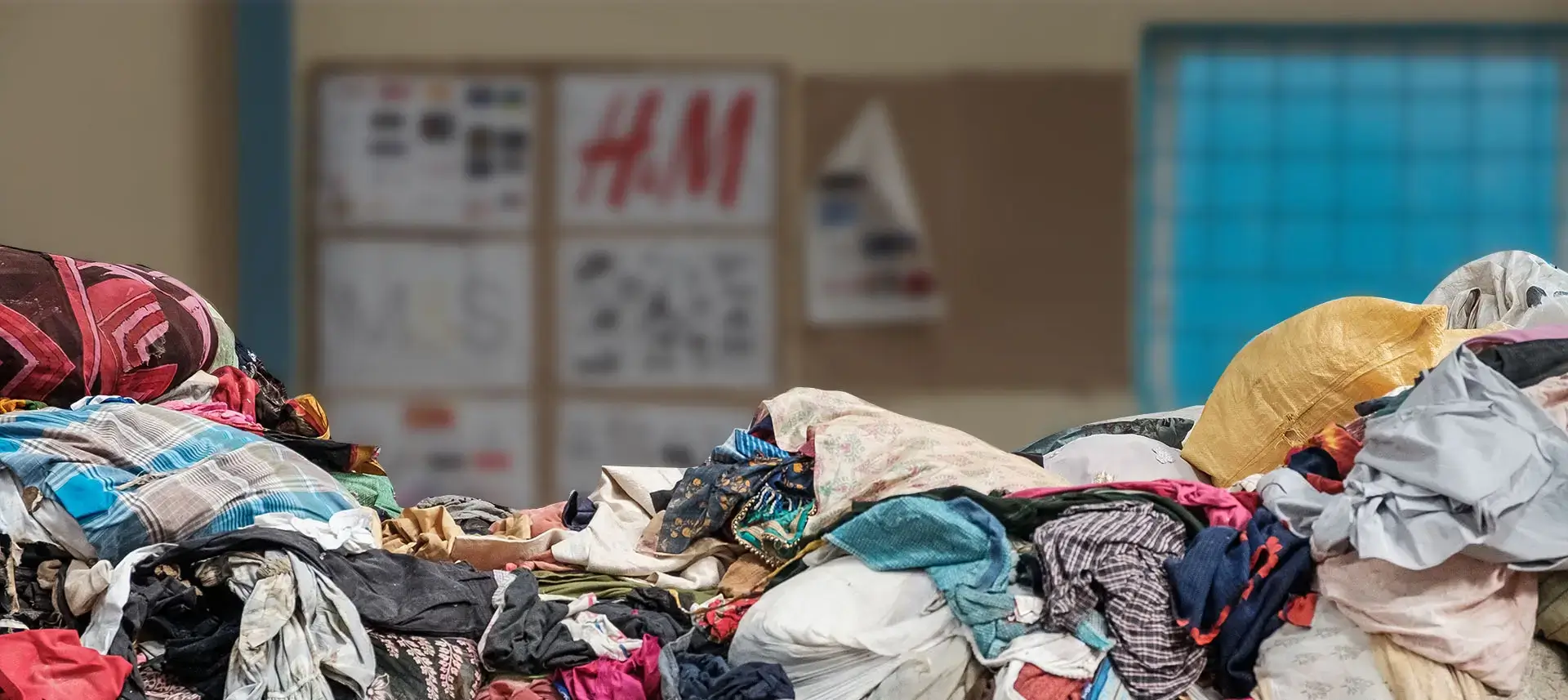 Textile waste landscape showing piles of discarded clothing and fabrics
